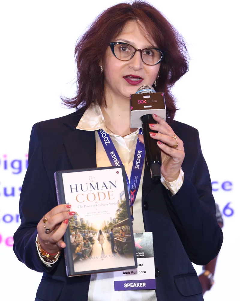 Anjali Dutta on stage holding The Human Code
